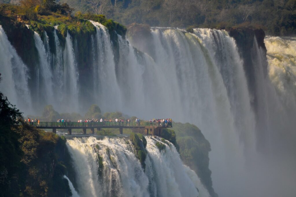 people looking at large waterfall