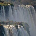 people looking at large waterfall
