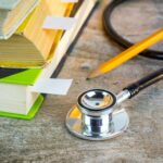 a stethoscope sitting on top of a pile of books